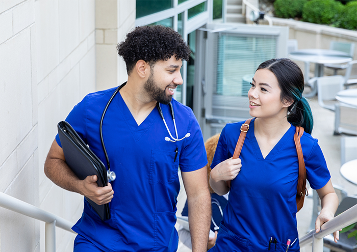 Nurse coworkers walking through hospital campus